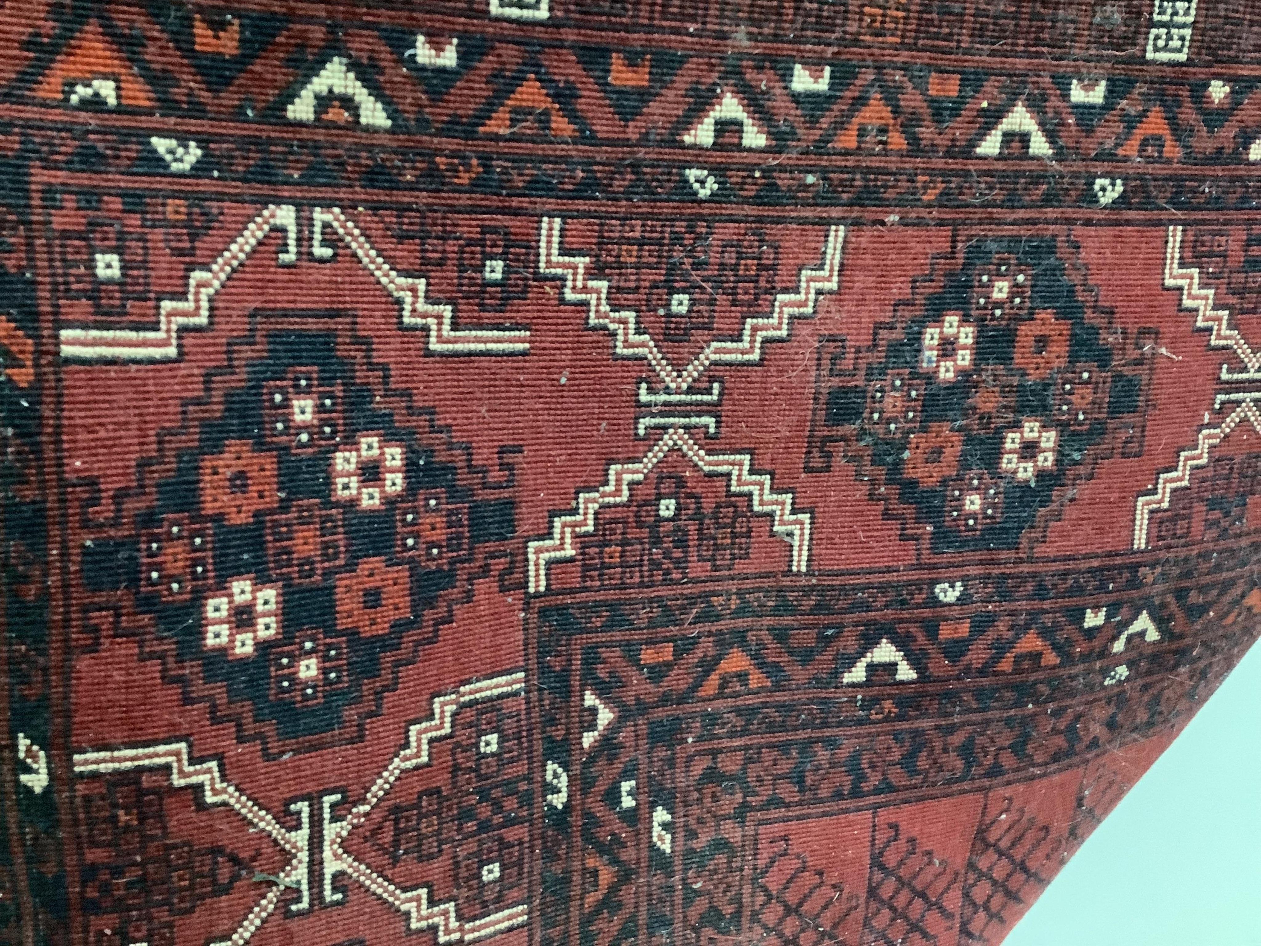 A Belouch red ground carpet, approximately 250cm x 160cm. Condition - fair to good